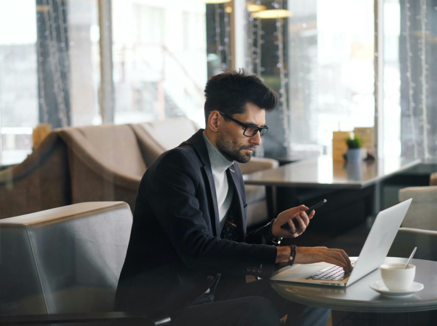 Centura Advisors financial planner working on investment strategies with laptop and phone in Baton Rouge